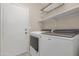 Laundry room features a modern washer and dryer, plus ample shelving for storage at 15437 S 23Rd Pl, Phoenix, AZ 85048
