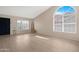 Bright living room with tile floors, large windows, and an arched window allowing natural light at 15437 S 23Rd Pl, Phoenix, AZ 85048