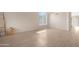 Bright living room with arched window, neutral walls, and light tile flooring at 15437 S 23Rd Pl, Phoenix, AZ 85048