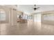 Spacious living room with tile floors, a ceiling fan, and an open layout to the kitchen at 15437 S 23Rd Pl, Phoenix, AZ 85048