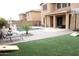 Backyard features a pool, patio, lawn, and desert landscaping at 15620 W Cameron Dr, Surprise, AZ 85379