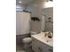 Bathroom featuring a vanity with white cabinets, modern fixtures, and shower with black and white striped curtain at 15620 W Cameron Dr, Surprise, AZ 85379