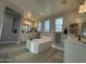 Bathroom featuring a large soaking tub, double sinks, and wood look floors at 15620 W Cameron Dr, Surprise, AZ 85379