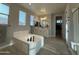 Large bathroom with a soaking tub, double sinks, a walk-in closet and walk-in shower at 15620 W Cameron Dr, Surprise, AZ 85379