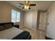 Bright bedroom features a ceiling fan, closet, window, and wood-look flooring at 15620 W Cameron Dr, Surprise, AZ 85379