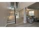 Bright foyer with soaring ceilings, staircase, and open access to the adjacent living room at 15620 W Cameron Dr, Surprise, AZ 85379