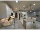 Modern kitchen with white cabinets, stainless steel appliances, granite counters, and open layout at 15620 W Cameron Dr, Surprise, AZ 85379