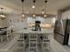 Modern kitchen featuring granite counters, stainless steel appliances, and stylish pendant lighting at 15620 W Cameron Dr, Surprise, AZ 85379