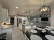 Bright kitchen with stainless steel appliances, granite countertops, and a dining area with stylish lighting at 15620 W Cameron Dr, Surprise, AZ 85379