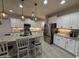 Modern kitchen with granite countertops, stainless steel appliances, and sleek white cabinetry at 15620 W Cameron Dr, Surprise, AZ 85379
