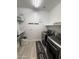 Functional laundry room with modern washer and dryer and storage shelves, providing efficient space at 15620 W Cameron Dr, Surprise, AZ 85379