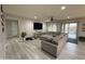 Spacious living room featuring a large sectional, TV, and sliding glass doors to the outdoor area at 15620 W Cameron Dr, Surprise, AZ 85379