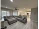 Expansive living room with a sectional sofa, open layout, and views into the kitchen and dining area at 15620 W Cameron Dr, Surprise, AZ 85379