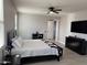 This main bedroom features a ceiling fan, TV and a private entry to the main bath at 15620 W Cameron Dr, Surprise, AZ 85379