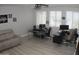 Comfortable home office featuring two desks, an ergonomic chairs, and a cozy couch for a productive work environment at 15620 W Cameron Dr, Surprise, AZ 85379