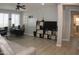 Spacious office with two desks, a comfortable couch, natural light, and a ceiling fan, creating a productive workspace at 15620 W Cameron Dr, Surprise, AZ 85379