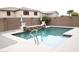 Outdoor pool with a water feature and stone pavers at 15620 W Cameron Dr, Surprise, AZ 85379