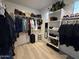 A well-organized walk-in closet with hanging clothes, shelves, and drawers for ample storage at 15620 W Cameron Dr, Surprise, AZ 85379