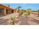 Large back yard featuring rock ground cover, desert landscaping, and covered porch at 15834 W Avalon Dr, Goodyear, AZ 85395