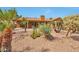 Landscaped backyard with lush desert plants and palm trees complements this beautiful home at 15834 W Avalon Dr, Goodyear, AZ 85395