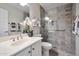 Bathroom featuring a stylish shower, vanity with sink, and decorative floral arrangement at 15834 W Avalon Dr, Goodyear, AZ 85395