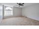 This carpeted bedroom features a modern ceiling fan and a window with white shutters at 15834 W Avalon Dr, Goodyear, AZ 85395