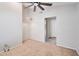 Carpeted bedroom featuring a ceiling fan, decorative light fixture, and an open doorway at 15834 W Avalon Dr, Goodyear, AZ 85395