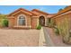 Charming home featuring desert landscaping and a covered entryway at 15834 W Avalon Dr, Goodyear, AZ 85395