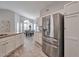 Spacious kitchen showcasing stainless steel refrigerator and tile flooring, next to the dining area at 15834 W Avalon Dr, Goodyear, AZ 85395