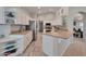 Bright kitchen features white cabinetry, modern appliances, and seamless flow to dining area at 15834 W Avalon Dr, Goodyear, AZ 85395