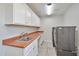 Well-equipped laundry room with ample cabinet space, countertop, sink, and modern machines at 15834 W Avalon Dr, Goodyear, AZ 85395