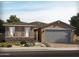 Charming single-story home with stone accents, a two-car garage, and a well-manicured front yard at 159 N 175Th Ave, Goodyear, AZ 85338
