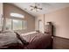 Well-lit bedroom boasts wood floors, a ceiling fan, and ample natural light at 16187 W Gibson Ln, Goodyear, AZ 85338