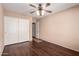 Bedroom with wood floor and a closet with sliding doors at 16187 W Gibson Ln, Goodyear, AZ 85338