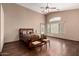 Spacious bedroom with a ceiling fan, hardwood floors, and a large window at 16187 W Gibson Ln, Goodyear, AZ 85338