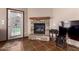 Stone fireplace and tile flooring next to a door leading to the outside at 16187 W Gibson Ln, Goodyear, AZ 85338