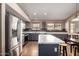 Spacious kitchen features an island with white countertops and stainless steel appliances at 16187 W Gibson Ln, Goodyear, AZ 85338