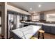 Kitchen features an island with white countertops and stainless steel appliances at 16187 W Gibson Ln, Goodyear, AZ 85338