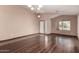 Inviting living room featuring wood floors, large windows, and a chandelier at 16187 W Gibson Ln, Goodyear, AZ 85338