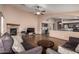 Comfortable living room featuring a stone fireplace, and an open layout to the kitchen area at 16187 W Gibson Ln, Goodyear, AZ 85338
