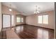 Welcoming living room featuring vaulted ceilings, wood floors, and a side window at 16187 W Gibson Ln, Goodyear, AZ 85338