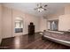 Spacious main bedroom boasts wood floors and connects to the main bath with dual sinks and gray cabinetry at 16187 W Gibson Ln, Goodyear, AZ 85338