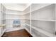 Walk-in pantry with ample white shelving for organized storage at 16187 W Gibson Ln, Goodyear, AZ 85338