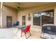 Relaxing covered patio with a ceiling fan, grill, and outdoor seating, perfect for entertaining at 16187 W Gibson Ln, Goodyear, AZ 85338