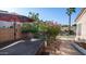 Cozy back patio featuring a hot tub, shade umbrella, and lush flowering oleander bushes at 1620 W Nighthawk Way, Phoenix, AZ 85045