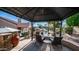 Covered patio area overlooking a pool and lushly landscaped backyard, perfect for outdoor relaxation at 1620 W Nighthawk Way, Phoenix, AZ 85045