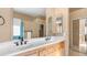 Bathroom featuring double sinks, a vanity with cabinets, and large mirror at 1620 W Nighthawk Way, Phoenix, AZ 85045