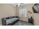 Bedroom with a twin-sized bed, wood-look flooring, and shutters for natural light at 1620 W Nighthawk Way, Phoenix, AZ 85045
