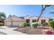 Charming single-story home featuring a three-car garage, desert landscaping, and flag at 1620 W Nighthawk Way, Phoenix, AZ 85045