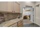 Hallway with granite countertops and decorative tiling leading to a sunlit bedroom at 1620 W Nighthawk Way, Phoenix, AZ 85045